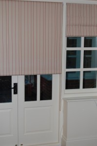 Photo of roller blind in red striped fabric over a set of french doors